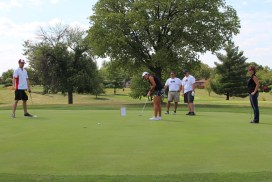 people golfing